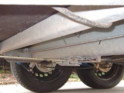 The underside of a tandem boat trailer showing the brakes...